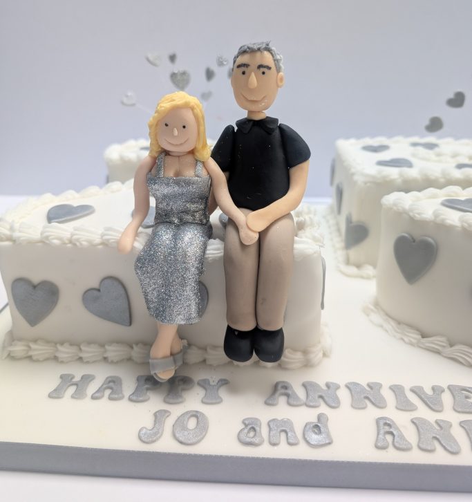 Close up of the 25th Wedding anniversary cake with the happy couple