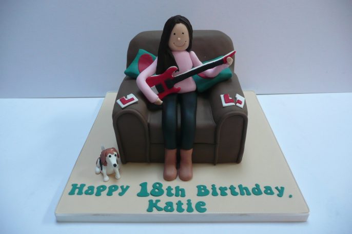 Girl in chair playing the Guitar